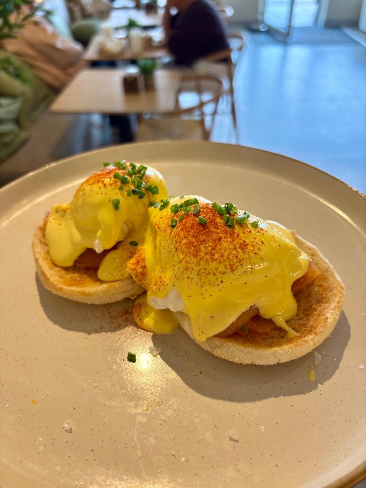 Eggs Royale — two poached eggs and smoked salmon on toasted English muffins, finished with house hollandaise and chives