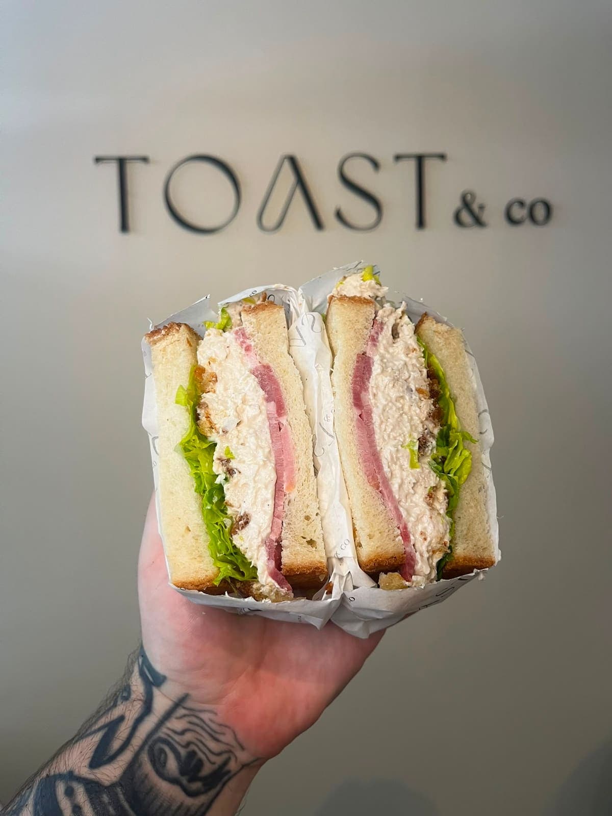 Chicken Caesar sandwich with pulled chicken, romaine lettuce, Caesar sauce and smoked bacon on farmhouse bread at TOAST & Co Derby